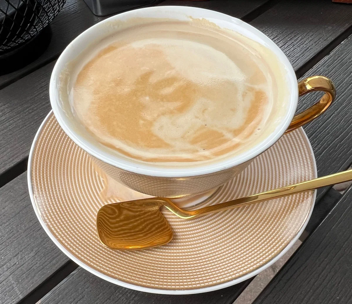 Latte with a gold spoon at a Miami café